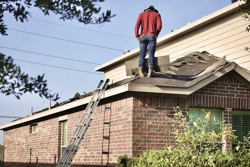 Professional roofer working on a residential roof in Vandenberg Village